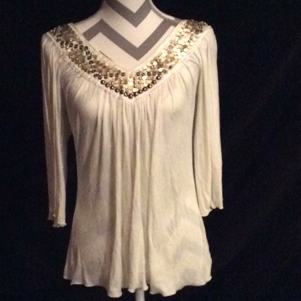 Top with v neck line. Embelished neck line